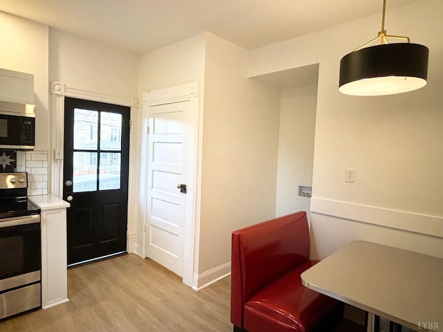 850 Rivermont Ave, Lynchburg, VA 24504 - kitchen with appliances with stainless steel finishes, light wood-style floors, tasteful backsplash, light countertops, and baseboards
