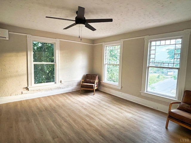 850 Rivermont Ave, Lynchburg, VA 24504 - unfurnished room with baseboards, wood finished floors, a textured ceiling, a ceiling fan, and an AC wall unit