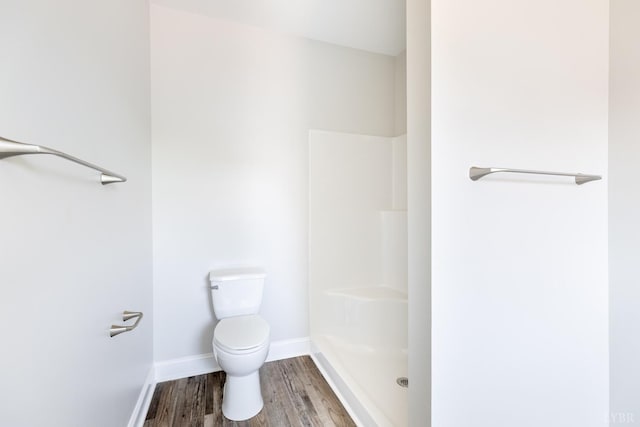243 Pebble Rd, Rustburg, VA 24588 - bathroom with baseboards, wood finished floors, toilet, and a shower