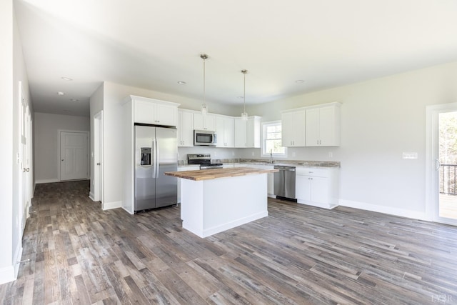 243 Pebble Rd, Rustburg, VA 24588 - kitchen featuring appliances with stainless steel finishes, butcher block counters, dark wood-type flooring, a kitchen island, and white cabinets