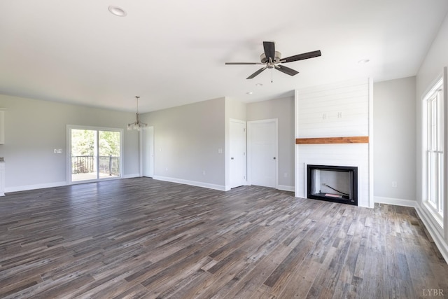 243 Pebble Rd, Rustburg, VA 24588 - unfurnished living room featuring a large fireplace, dark wood finished floors, ceiling fan, a chandelier, and baseboards