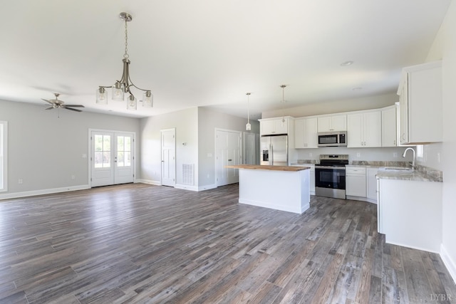 243 Pebble Rd, Rustburg, VA 24588 - kitchen featuring appliances with stainless steel finishes, a sink, open floor plan, a center island, and dark wood finished floors