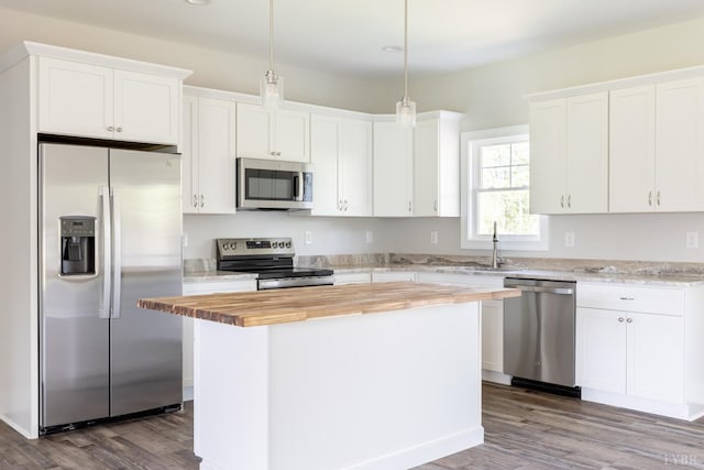 243 Pebble Rd, Rustburg, VA 24588 - kitchen with stainless steel appliances, butcher block countertops, dark wood-style flooring, white cabinetry, and a kitchen island