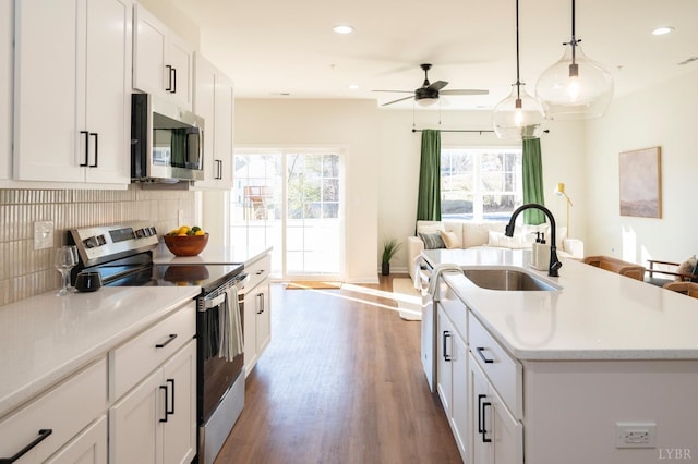 128 Brenleigh Ct Unit 108, Lynchburg, VA 24501 - kitchen with stainless steel appliances, a sink, open floor plan, decorative backsplash, and a ceiling fan