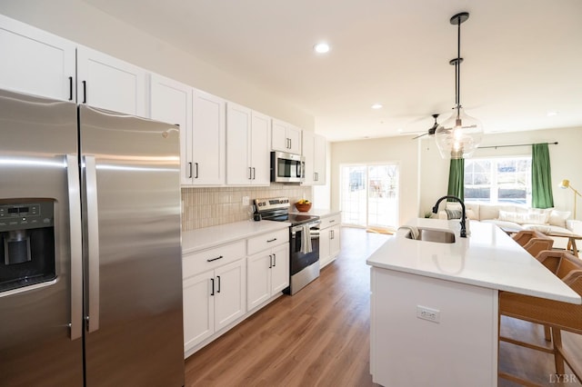 128 Brenleigh Ct Unit 108, Lynchburg, VA 24501 - kitchen with appliances with stainless steel finishes, a sink, backsplash, open floor plan, and white cabinetry