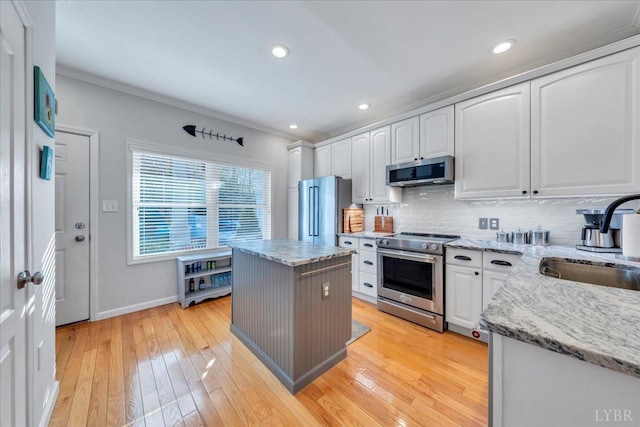 231 Mountain Cove Dr Unit 5, Hardy, VA 24101 - kitchen featuring high quality appliances, white cabinets, backsplash, light stone counters, and ornamental molding