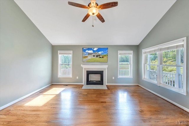 1400 Mountain Cut Rd, Appomattox, VA 24522 - unfurnished living room featuring wood finished floors, a ceiling fan, a fireplace with flush hearth, baseboards, and vaulted ceiling
