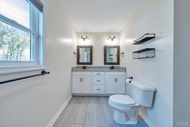 1400 Mountain Cut Rd, Appomattox, VA 24522 - bathroom featuring baseboards, a healthy amount of sunlight, toilet, and a sink