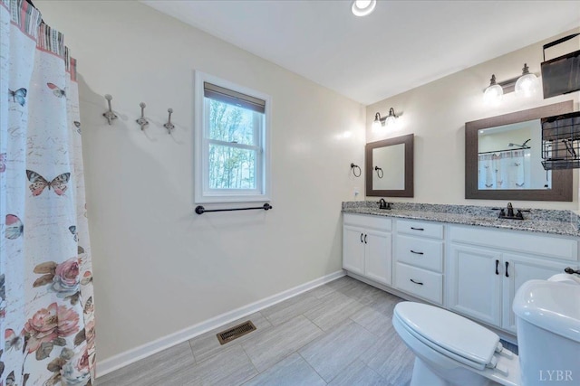 1400 Mountain Cut Rd, Appomattox, VA 24522 - full bath featuring toilet, a shower with curtain, visible vents, double vanity, and baseboards