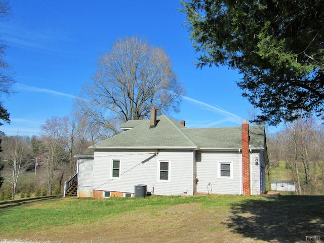 1697 S Amherst Hwy, Amherst, VA 24521 - rear view of property with cooling unit, a chimney, a lawn, and roof with shingles