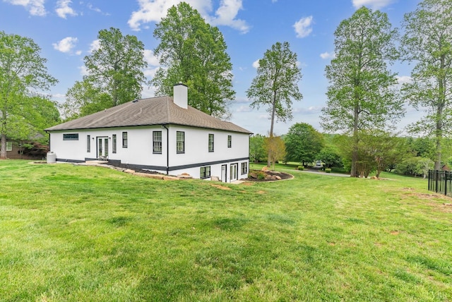 1208 Rocky Branch Dr, Forest, VA 24551 - back of house featuring a chimney, a lawn, and stucco siding