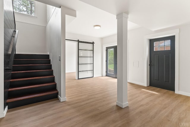 1208 Rocky Branch Dr, Forest, VA 24551 - entrance foyer with a barn door, baseboards, stairs, and wood finished floors