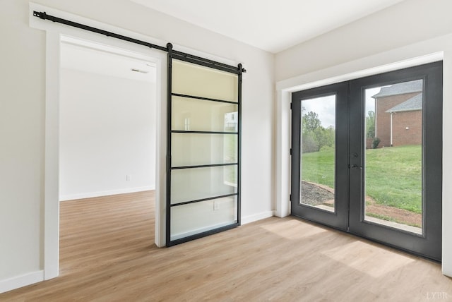 1208 Rocky Branch Dr, Forest, VA 24551 - doorway featuring a barn door, french doors, light wood-style floors, and baseboards