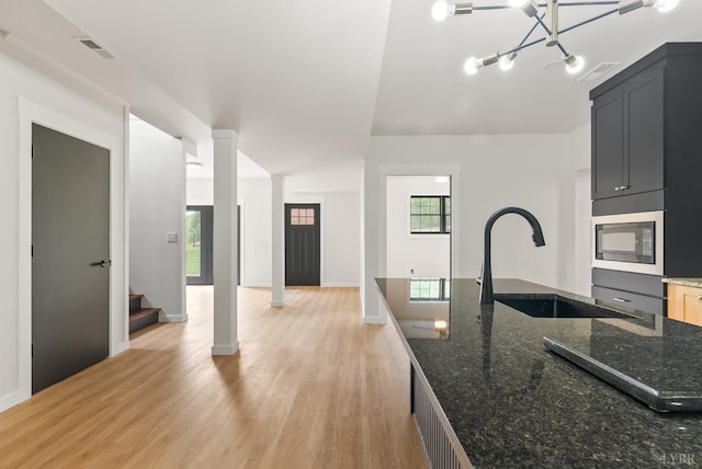 1208 Rocky Branch Dr, Forest, VA 24551 - kitchen featuring a sink, black microwave, light wood-type flooring, and dark stone counters