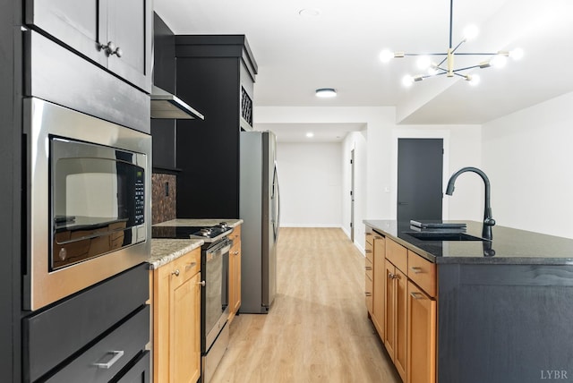 1208 Rocky Branch Dr, Forest, VA 24551 - kitchen featuring appliances with stainless steel finishes, a sink, light wood-style floors, a chandelier, and dark stone countertops