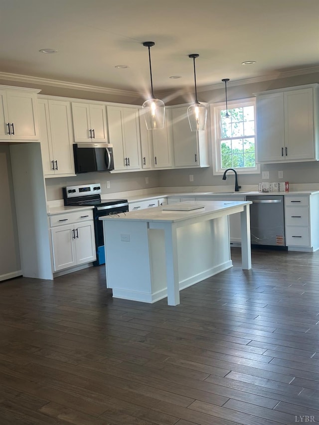 1493 Buck Creek Rd, Appomattox, VA 24522 - kitchen with stainless steel appliances, white cabinets, crown molding, light countertops, and hanging light fixtures