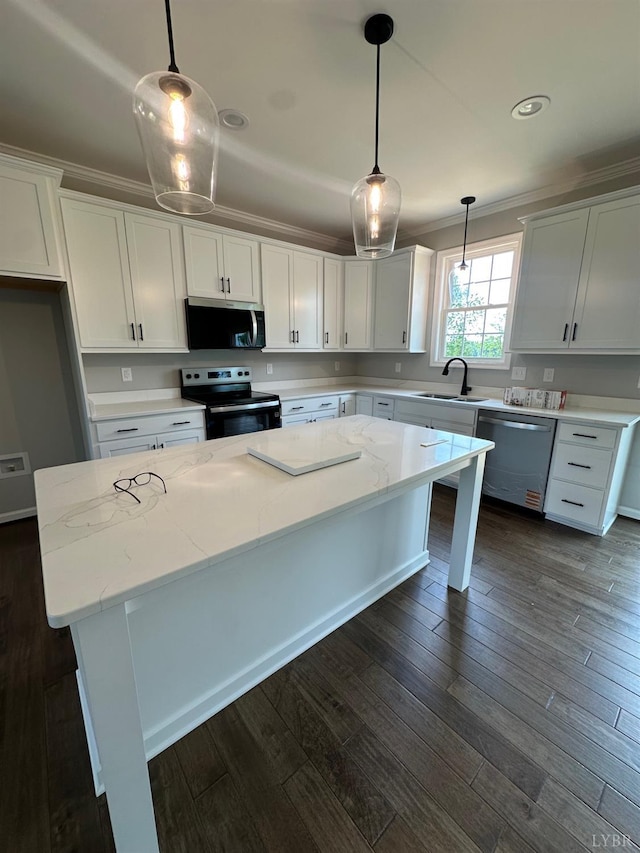 1493 Buck Creek Rd, Appomattox, VA 24522 - kitchen featuring appliances with stainless steel finishes, a center island, crown molding, white cabinetry, and light stone countertops