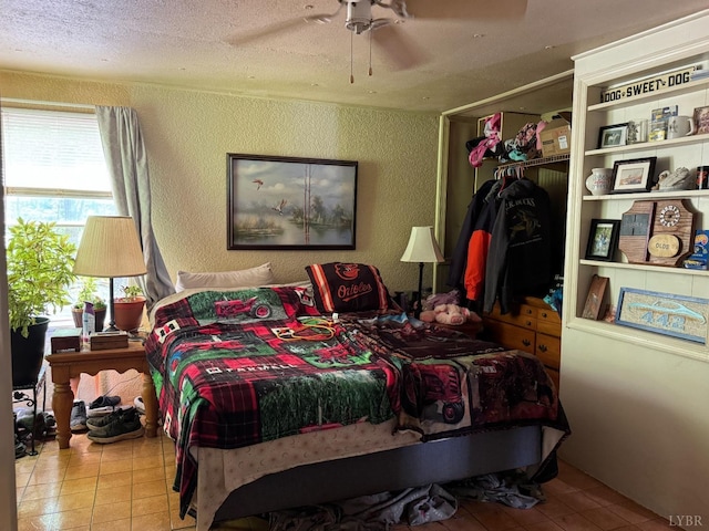202 Stallion Way, Amherst, VA 24521 - bedroom featuring tile patterned flooring, a textured wall, a closet, a textured ceiling, and ceiling fan