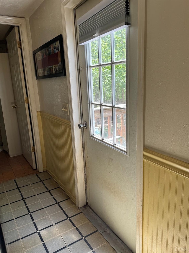 202 Stallion Way, Amherst, VA 24521 - hall with a wainscoted wall, healthy amount of natural light, light tile patterned floors, and a textured wall