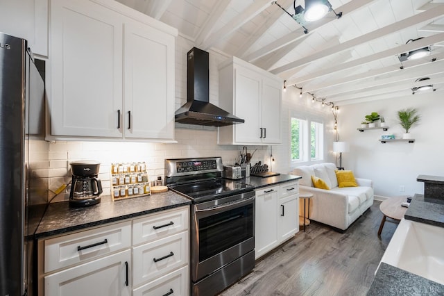 1132 Bancroft, Goode, VA 24556 - kitchen with stainless steel range with electric stovetop, wall chimney range hood, light wood-type flooring, white cabinets, and tasteful backsplash
