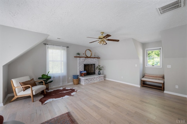 1132 Bancroft, Goode, VA 24556 - living area with visible vents, wood finished floors, a textured ceiling, a ceiling fan, and vaulted ceiling