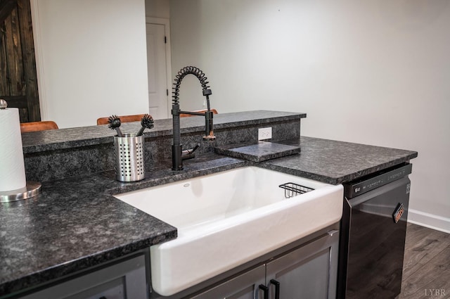 1132 Bancroft, Goode, VA 24556 - kitchen featuring dark wood-style flooring, dark countertops, a sink, baseboards, and black dishwasher