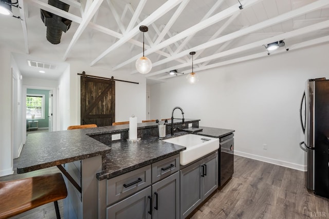1132 Bancroft, Goode, VA 24556 - kitchen with a breakfast bar, a barn door, a sink, freestanding refrigerator, and visible vents
