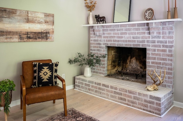 1132 Bancroft, Goode, VA 24556 - living area featuring baseboards, a brick fireplace, and wood finished floors