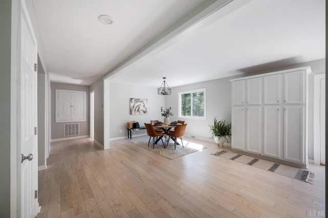 1132 Bancroft, Goode, VA 24556 - dining area with baseboards, a notable chandelier, light wood-type flooring, and visible vents