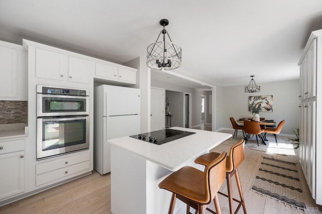 1132 Bancroft, Goode, VA 24556 - kitchen featuring an inviting chandelier, freestanding refrigerator, double oven, and black electric cooktop