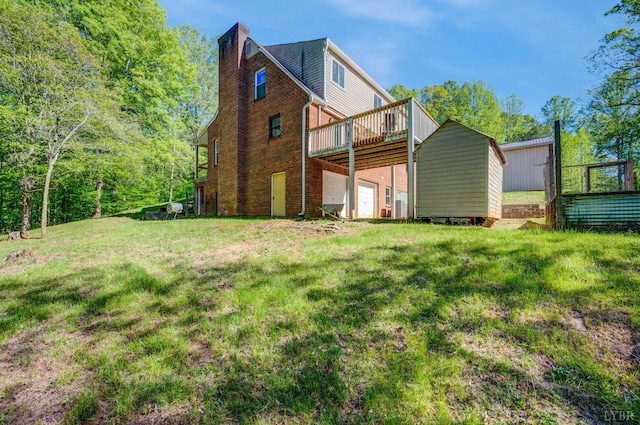 1132 Bancroft, Goode, VA 24556 - rear view of house with a garage, a wooden deck, a shed, a lawn, and an outdoor structure