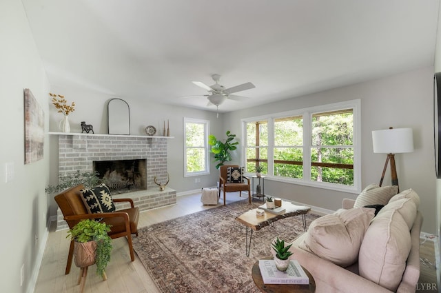 1132 Bancroft, Goode, VA 24556 - living area with a brick fireplace, baseboards, ceiling fan, and wood finished floors