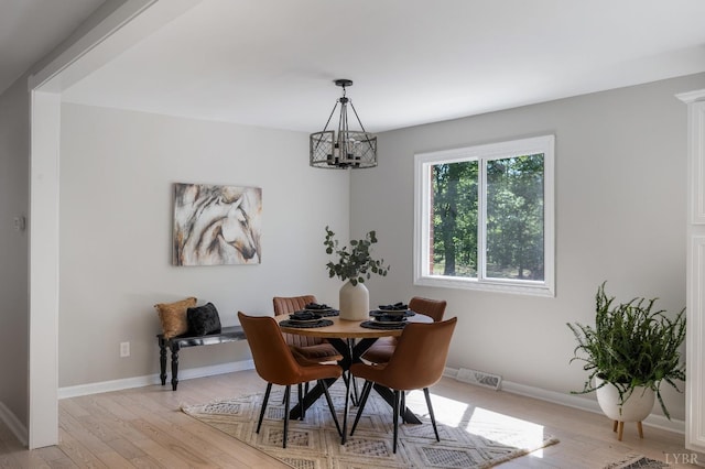 1132 Bancroft, Goode, VA 24556 - dining area featuring baseboards, visible vents, light wood finished floors, and a notable chandelier