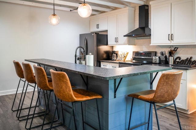 1132 Bancroft, Goode, VA 24556 - kitchen with dark countertops, wall chimney range hood, a kitchen bar, tasteful backsplash, and appliances with stainless steel finishes