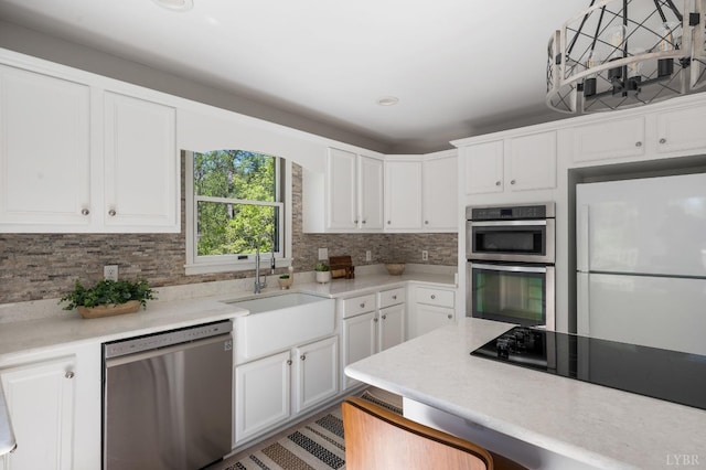 1132 Bancroft, Goode, VA 24556 - kitchen with a sink, white cabinets, backsplash, and stainless steel appliances