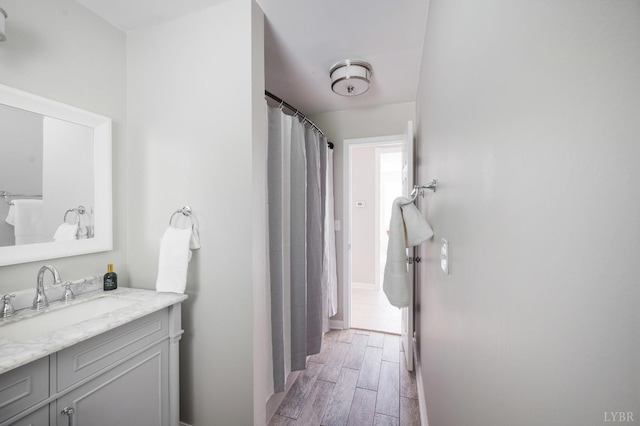 1132 Bancroft, Goode, VA 24556 - bathroom featuring vanity, baseboards, and wood finished floors