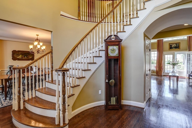 107 Emory Way, Amherst, VA 24521 - stairway featuring wood finished floors, a high ceiling, baseboards, arched walkways, and a chandelier