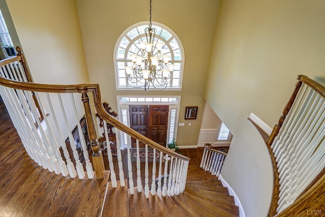 107 Emory Way, Amherst, VA 24521 - stairway with a chandelier, a towering ceiling, and wood finished floors