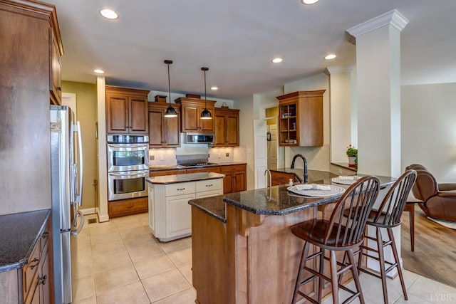 107 Emory Way, Amherst, VA 24521 - kitchen with backsplash, a peninsula, appliances with stainless steel finishes, and dark stone counters