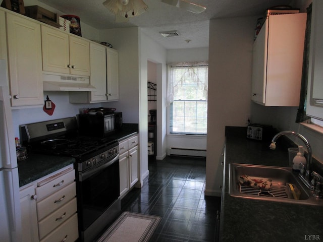 238 My Way, Amherst, VA 24521 - kitchen featuring gas stove, under cabinet range hood, dark countertops, white cabinets, and a baseboard radiator