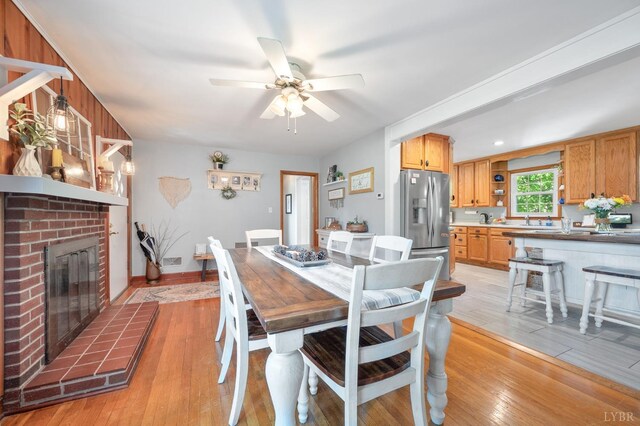 1206 Cedar Hill Dr, Lynchburg, VA 24502 - dining space with a ceiling fan, light wood-type flooring, and a fireplace