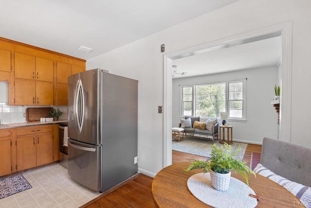 4600 Greenwood Dr, Lynchburg, VA 24502 - kitchen with stainless steel fridge, light countertops, light wood-type flooring, baseboards, and backsplash
