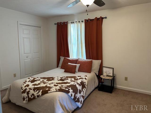 202 Rustwood Ct, Rustburg, VA 24588 - bedroom featuring a closet, a ceiling fan, baseboards, and light carpet