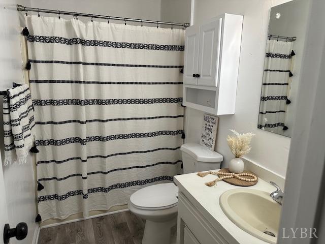 202 Rustwood Ct, Rustburg, VA 24588 - bathroom with vanity, a shower with shower curtain, wood finished floors, and toilet