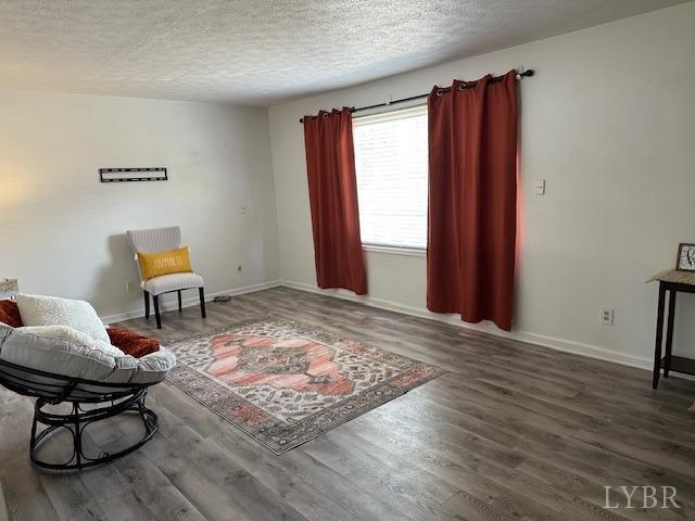 202 Rustwood Ct, Rustburg, VA 24588 - sitting room with baseboards, a textured ceiling, and wood finished floors