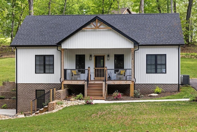 modern farmhouse style home featuring a porch, a front yard, central air condition unit, a shingled roof, and stairs