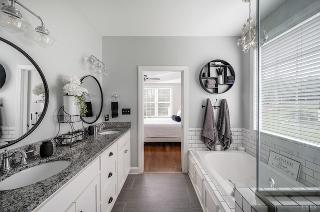 1205 Bradford Crossing Pl, Goode, VA 24556 - bathroom featuring a garden tub, a sink, ceiling fan, and ensuite bath