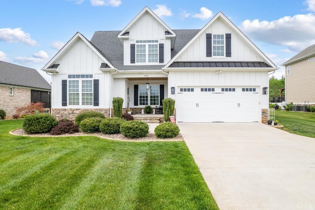 view of front of home featuring board and batten siding, driveway, a front yard, a garage, and a shingled roof