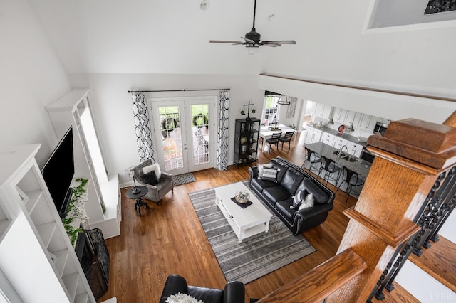 1205 Bradford Crossing Pl, Goode, VA 24556 - living area with french doors, ceiling fan, wood finished floors, and high vaulted ceiling
