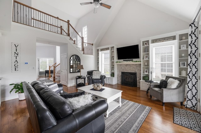 1205 Bradford Crossing Pl, Goode, VA 24556 - living area featuring wood finished floors, a fireplace, ceiling fan, high vaulted ceiling, and stairway